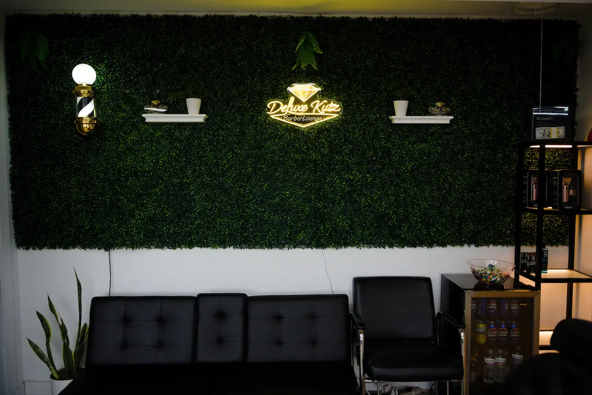 Deluxe Kutz waiting area with neon sign